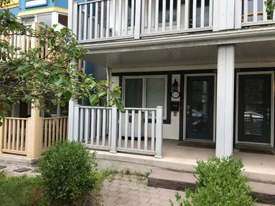 a house with a porch with a white fence at Toronto downtown Woodbine beaches private cozy room in Toronto