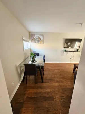 a dining room with a glass table with a plant on it at Spacious 2-bedroom ground floor unit near beach in Cobourg