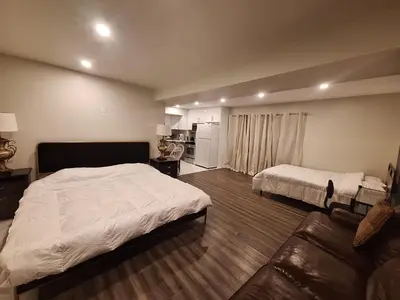 a large bedroom with a bed and a couch at Garden View in Schomberg