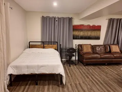 a bedroom with a bed and a couch at Garden View in Schomberg