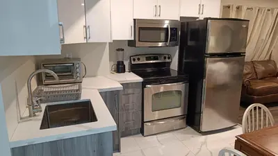 a kitchen with a stainless steel refrigerator and appliances at Garden View in Schomberg