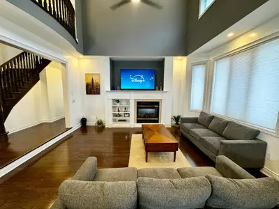 a living room with two couches and a tv at 3500 SqFt - Modern and Comfort - 4 BDRM Getaway - Relax - Unwind - Explore - Near Airport & Toronto Downtown in Brampton