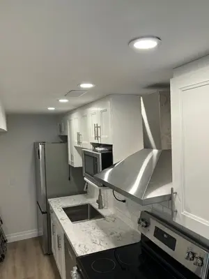 a kitchen with white cabinets and stainless steel appliances at One-Bedroom Unit at VISTA HILL in Waterloo