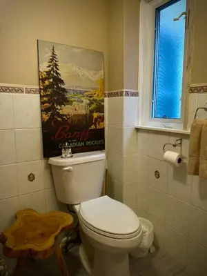 a bathroom with a toilet and a poster on the wall at Girls Night Out in Toronto
