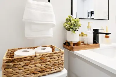 a bathroom with a basket of towels and a sink at Cozy 2BR Suite with Parking & Close to Niagara Falls and Sleeps 6 Guests in Niagara Falls