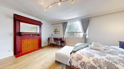 a bedroom with a bed and a desk and a window at Comfortable & Spacious Private Room with Ensuite in Corso Italia in Toronto