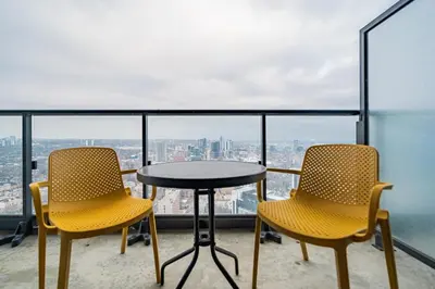 two chairs and a table on a balcony with a view at 2BR Condo close to Eaton Center in Toronto