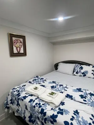 a bedroom with a bed with towels on it at Luxury Basement-Private Bdr & Bathroom with free parking In Toronto in Toronto