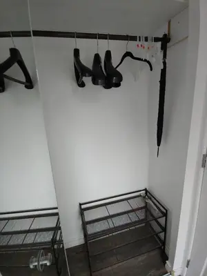a room with black shoes hanging on a wall at Two bedroom on Toronto Greenhills in Toronto