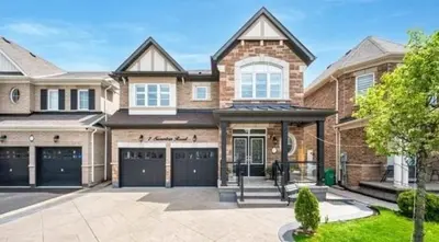 a large brick house with a garage at Beautiful 4 bed 3 master bedrooms-pvt washrooms in Brampton