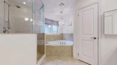 a bathroom with a tub and a shower and a sink at Connected Comfort - 7BR Family Retreat - Near Pearson Airport & Toronto Downtown in Brampton