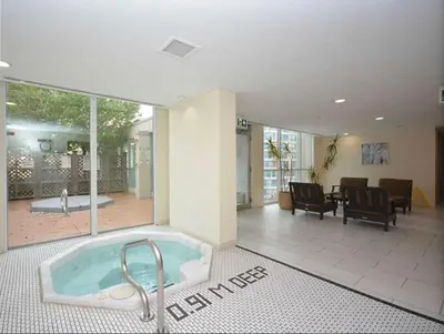 a large room with a tub in a house at Cityscape in Mississauga