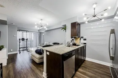 a kitchen with a sink and a refrigerator at Urban Oasis - Modern 1 bedroom w pool access free parking in Toronto