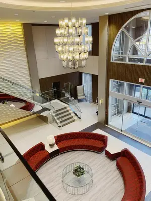 a lobby with red chairs and a chandelier at Urban Oasis - Modern 1 bedroom w pool access free parking in Toronto