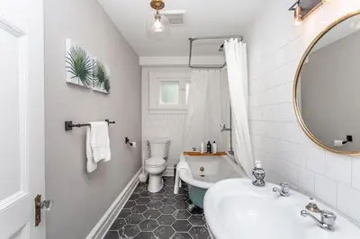 a bathroom with a sink and a tub and a toilet at Boutique Quality Home Downtown by the Shaw in Niagara on the Lake