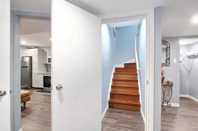a hallway with a stairway leading up to a house at Deluxe Apartment in Caledon