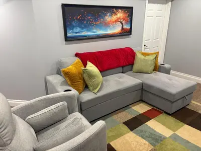 a living room with a couch and two chairs at Bolster in Uxbridge