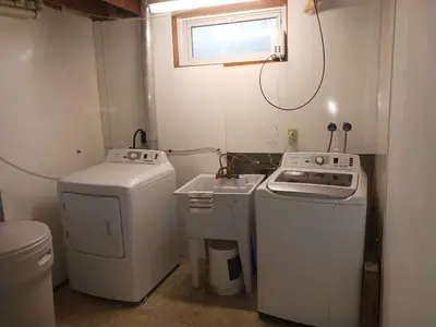 a small kitchen with a stove and a washer at Smart Budget Friendly Room-Near Airport, Groceries,College in Kitchener