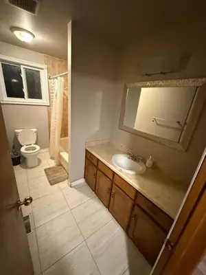a bathroom with a sink and a toilet and a mirror at Smart Budget Friendly Room-Near Airport, Groceries,College in Kitchener