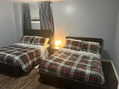 a bedroom with two beds and a window at Deluxe Apartment in Caledon