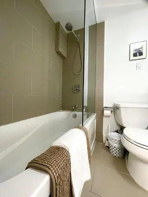 a bathroom with a bath tub and a toilet at Excellent Private Suite in Bloor West Village in Toronto