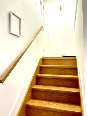 a staircase in a house with wooden floors and a window at Excellent Private Suite in Bloor West Village in Toronto