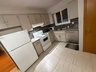 a kitchen with white appliances and white cabinets at HEAVY PRICE CUT-BOOK NOW!- Next to Airport, Downtown,Transit in Kitchener