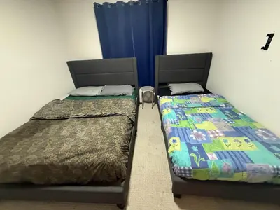 two beds sitting next to each other in a room at HOMESTAY NEXT TO SQUARE ONE MALL- 5 Mins Airport-24 HRS CHECKIN-MAJOR COST CUT in Mississauga