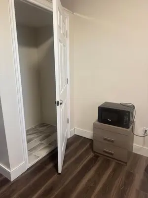 a room with a door and a tv on a dresser at Decor Dreams in Stayner