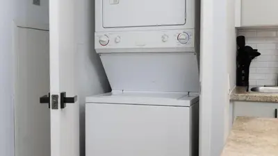 a white refrigerator in a kitchen with a microwave at Modern 1BR Condo in Church Yonge Corridor in Toronto