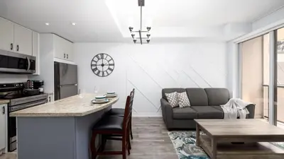 a kitchen and living room with a couch and a table at Modern 1BR Condo in Church Yonge Corridor in Toronto