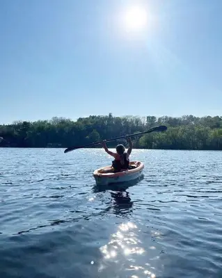 a person in a kayak on a lake at Wildwood Bunkies in Bailieboro