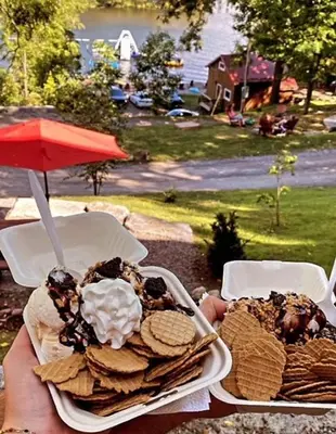 a person holding two plates of food on a table at Wildwood Bunkies in Bailieboro