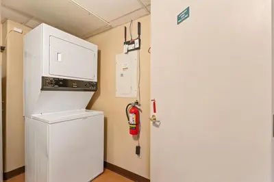 a kitchen with a white refrigerator and a fire extinguisher at Resort Style with Balcony Hot Tub and Full Kitchen in Edgar
