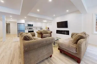 a living room with two couches and a tv at Luxhome25 in Aurora