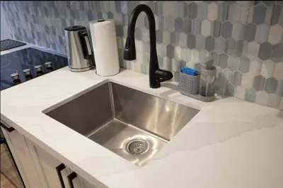 a kitchen sink with a faucet on a counter at Casa Hotel Stylish Suite with Patio in Leslieville in Toronto