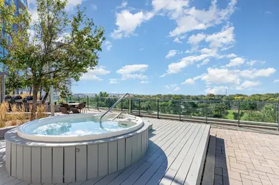 a hot tub on a patio with a view at Downtown Cozy 1BR Condo- Steps from Lake & King street in Toronto
