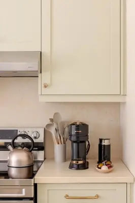 a kitchen counter with a coffee maker and utensils at The California Sunset in St. Catharines
