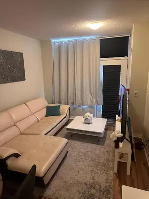 a living room with a couch and a table at Private Cozy Room in Mississauga