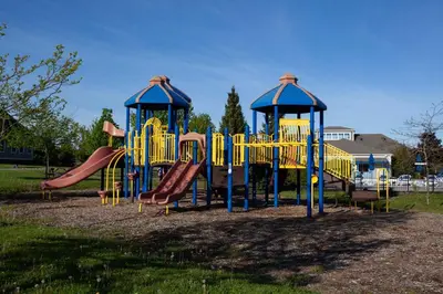 a playground with yellow and blue equipment in a park at The Balsam - 36 Farm View in Cherry Valley