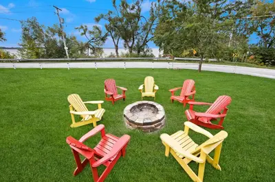 a group of chairs sitting around a fire pit at PRIVATE COTTAGE GETAWAY On LAKE SIMCOE in Brechin