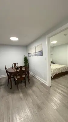 a dining room with a table and a bed at Brand new 2 bedroom basement apartment in Ajax