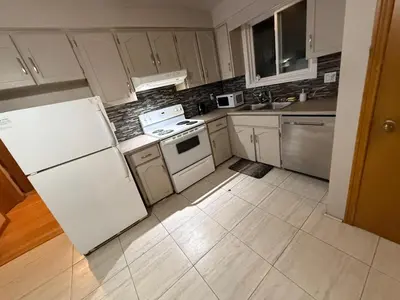 a kitchen with white cabinets and a white refrigerator at Affordable Family Room for 4 People-24Hrs Checkin-Next To Downtown,Airport in Kitchener