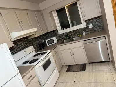 a kitchen with white cabinets and white appliances at Upper Level Cheap Room For 3 People- 24 Hrs Checkin-Walking to Bus,Grocery, Plaza in Kitchener