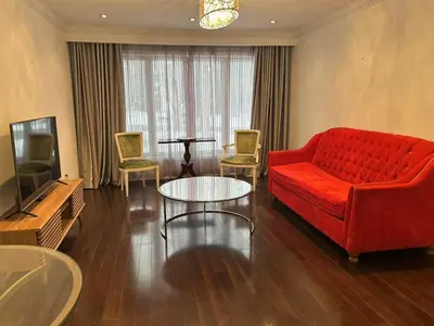 a living room with a red couch and a tv at Cozy Room for Two Unionville Area Twin Beds or King Minimum Stay 30 Days in Markham
