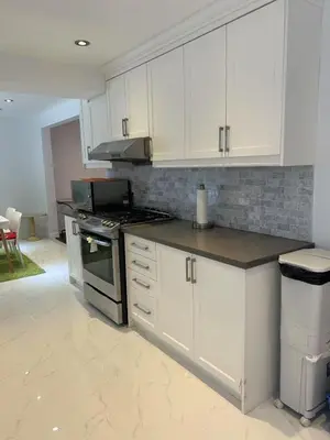 a kitchen with white cabinets and a stove at Cozy Room for Two Unionville Area Twin Beds or King Minimum Stay 30 Days in Markham