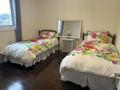 a bedroom with two beds and a mirror at Cozy Room for Two Unionville Area Twin Beds or King Minimum Stay 30 Days in Markham