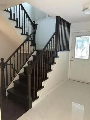 a staircase with black railings in a house at Cozy Room for Two Unionville Area Twin Beds or King Minimum Stay 30 Days in Markham