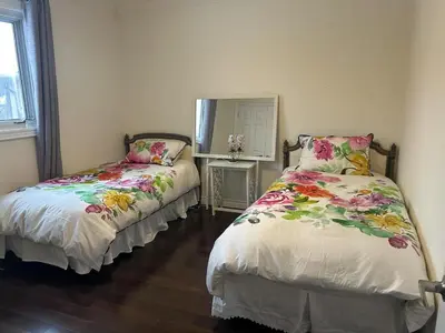 a bedroom with two beds and a mirror at Cozy Room for Two Unionville Area Twin Beds or King Minimum Stay 30 Days in Markham