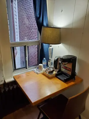 a wooden table with a coffee maker and a printer on it at Toronto Little Italy Guest House in Toronto